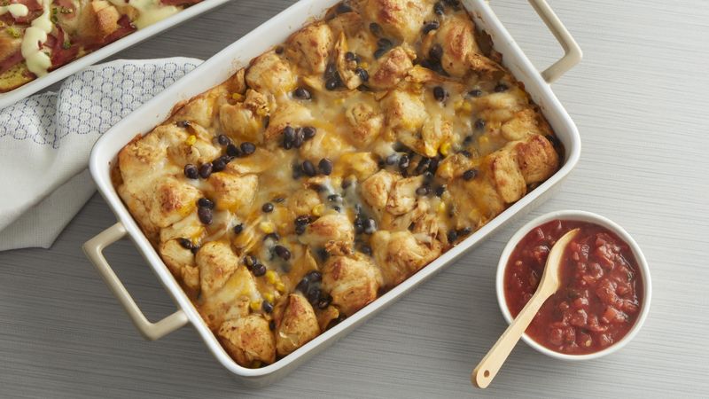 Chicken Taco Bubble-Up prepared recipe in a casserole dish with a side bowl of salsa