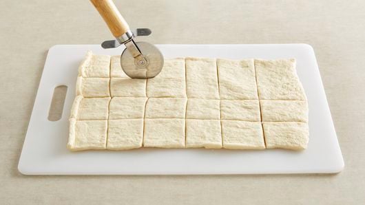 Prepping the cream cheese and sausage filling in Pillsbury Crescent dough  sheets - The Southerly Magnolia