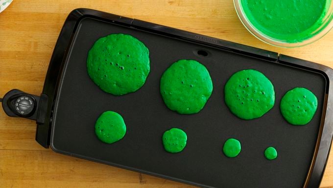 Image Of Green Pancake Shaped As Christmas Tree Cooking In Nonstick Frying  Pan For Childrens Breakfast On Xmas Day Christmas Tree Pancakes Ready To Be  Decorated With Fruit Baubles And Star Shaped