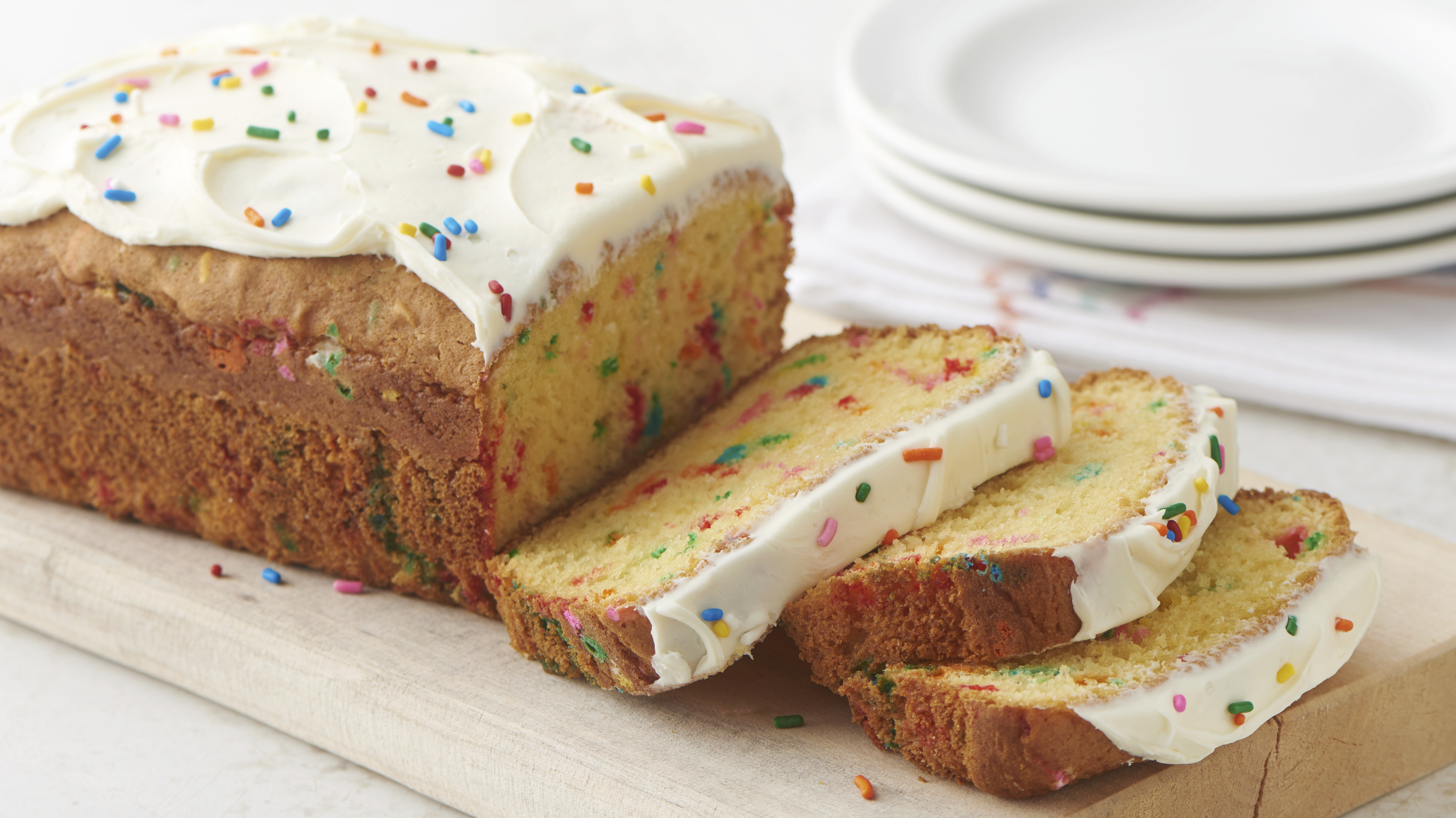 A birthday cake made from a loaf of bread with four party candles Stock  Photo - Alamy