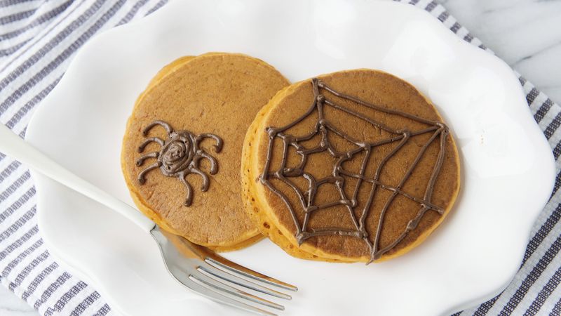 Pumpkin Pancakes with Halloween Spiderwebs